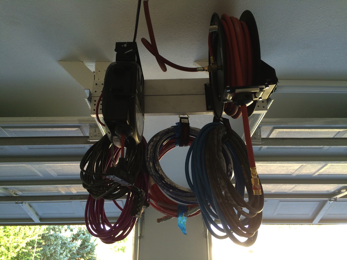 Ceiling-mounted hose and cable reels routed through the shop